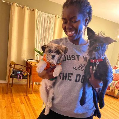 Camille Winbush holding her two dogs, Fran and Oscar.